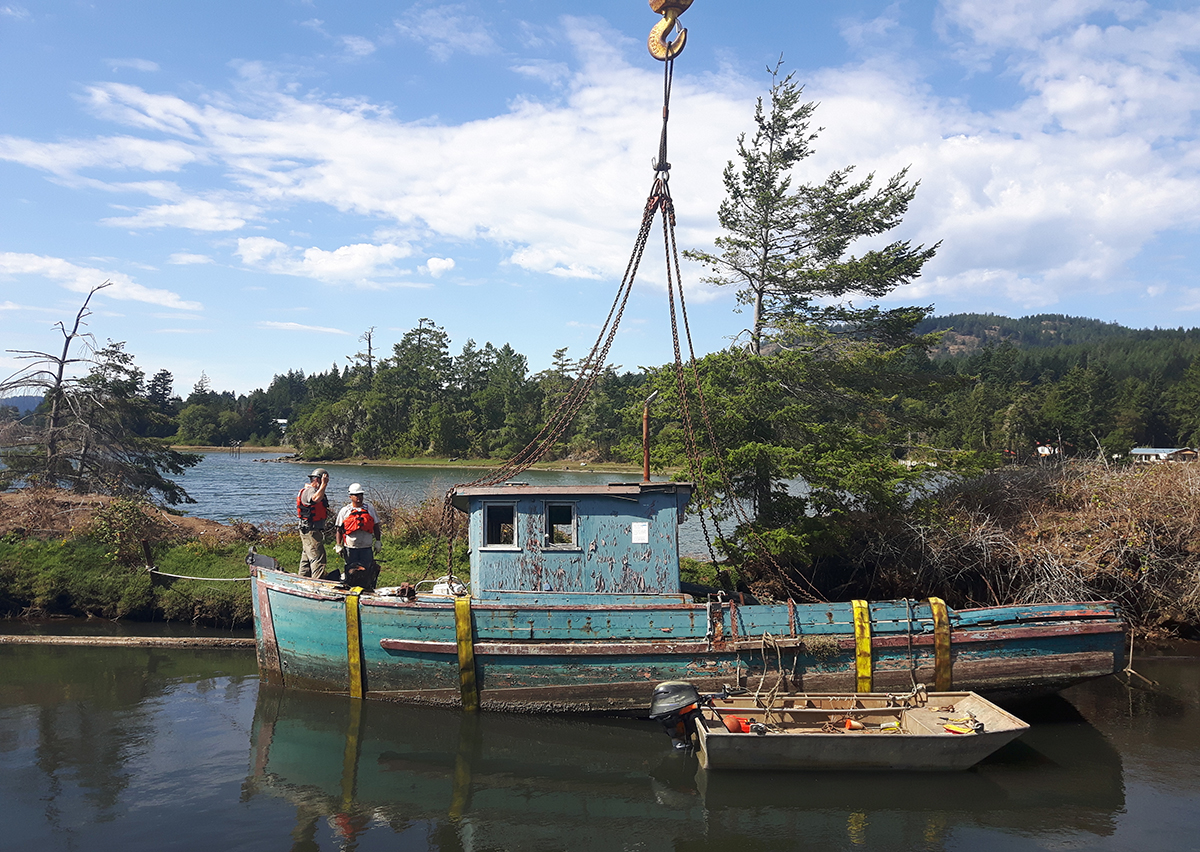 An abandoned boat being removed thanks to funding from the Oceans Protection Plan