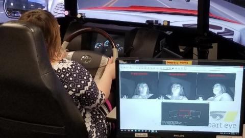 A person using in-house driving simulator